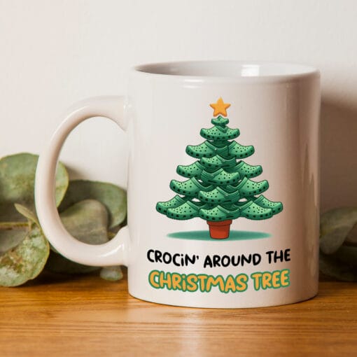 The perfect mug for a croc addict. It has the words "Crocin' Around The Christmas Tree" and an image of a Christmas tree made from crocs