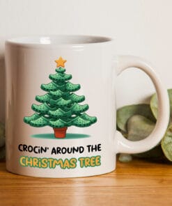 The perfect mug for a croc addict. It has the words "Crocin' Around The Christmas Tree" and an image of a Christmas tree made from crocs